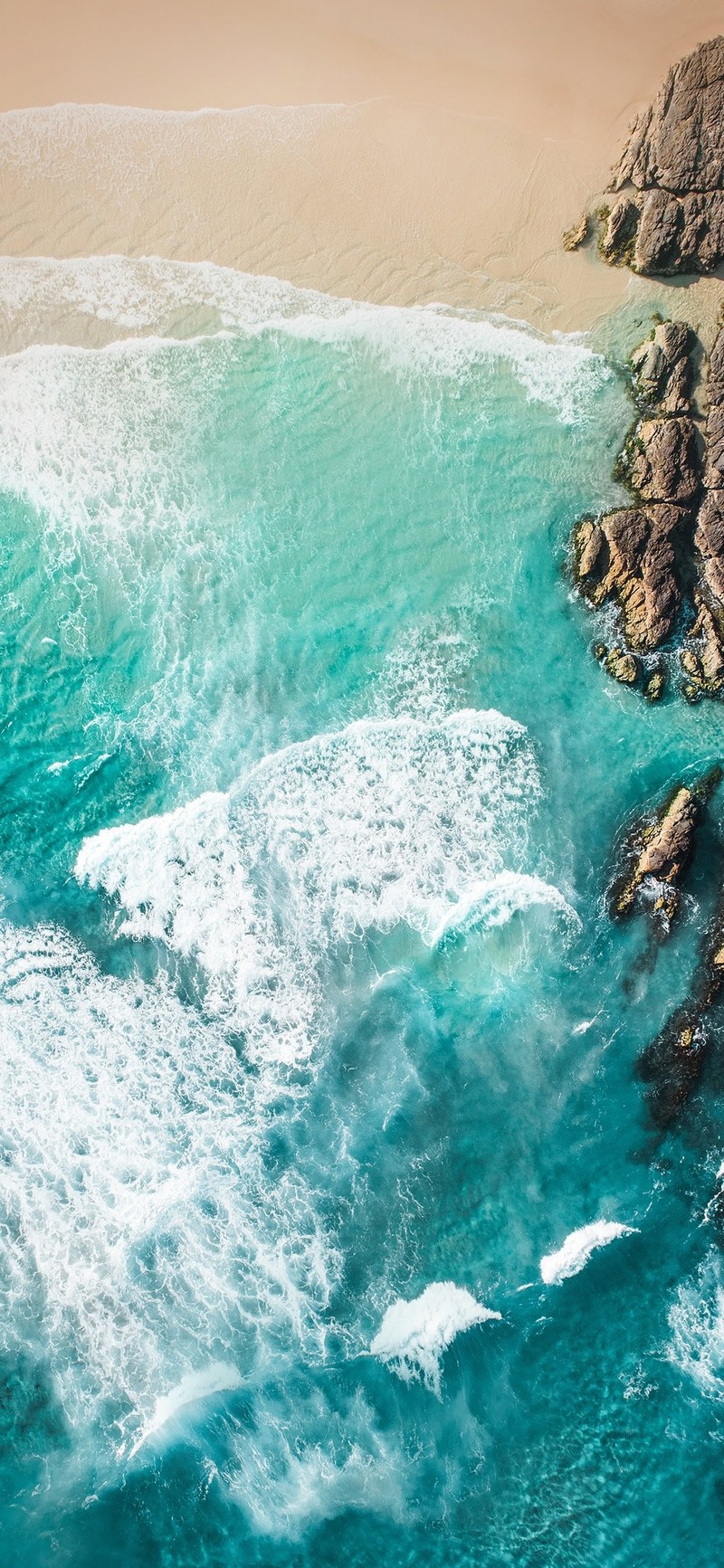 Aerial view of a beach with a body of water and a rocky shoreline (asus, asus zenfone, asus zenfone 6, oneplus 6t, fhd)