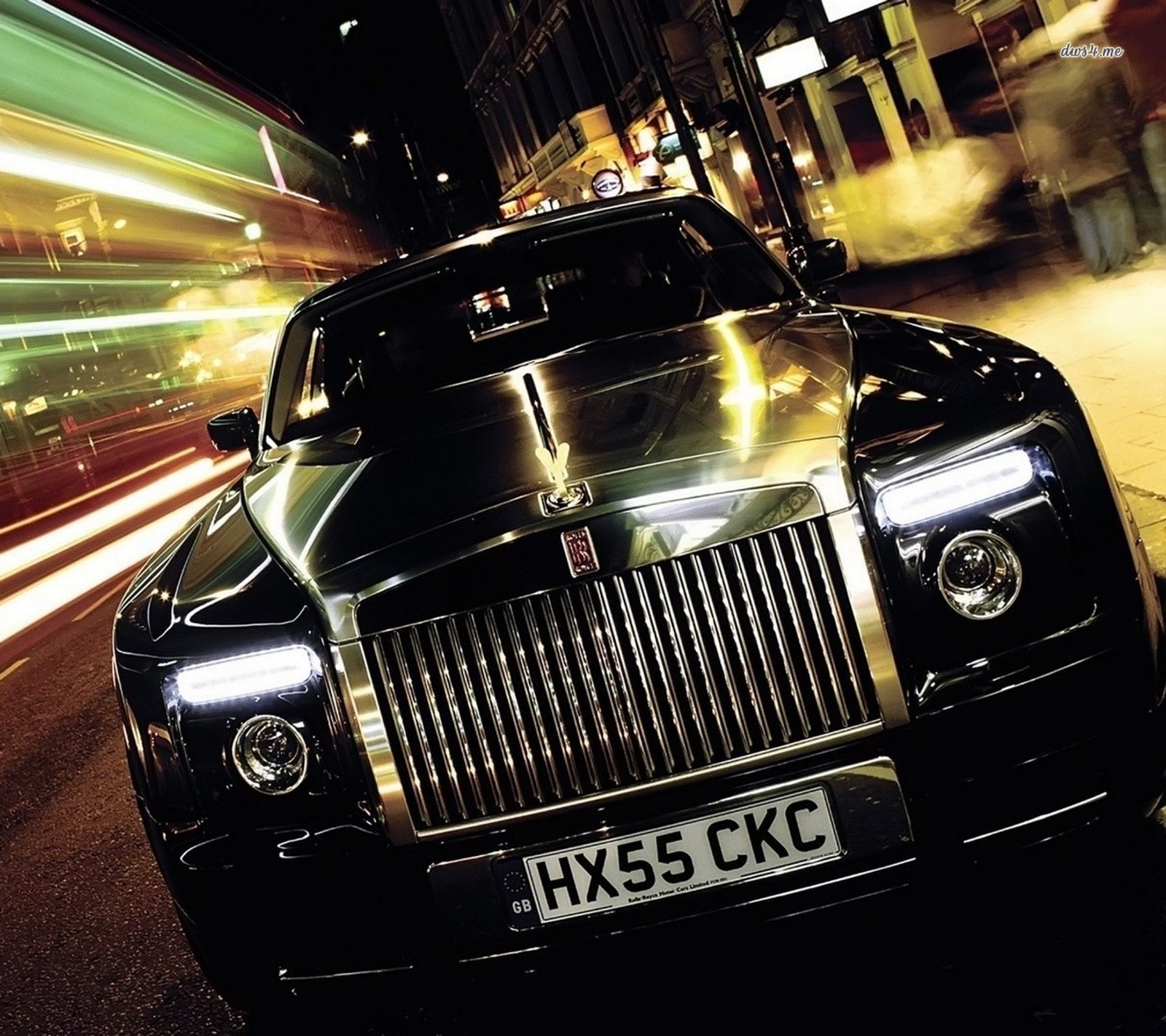 Arafed rolls royce car on a city street at night (auto, awesome, black, car, cool)