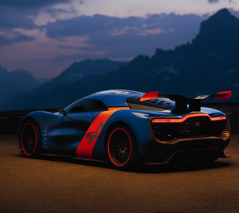 Ein blaues und rotes sportauto, das an einer straße vor bergen parkt (blau, natur, nacht, renault alpine)