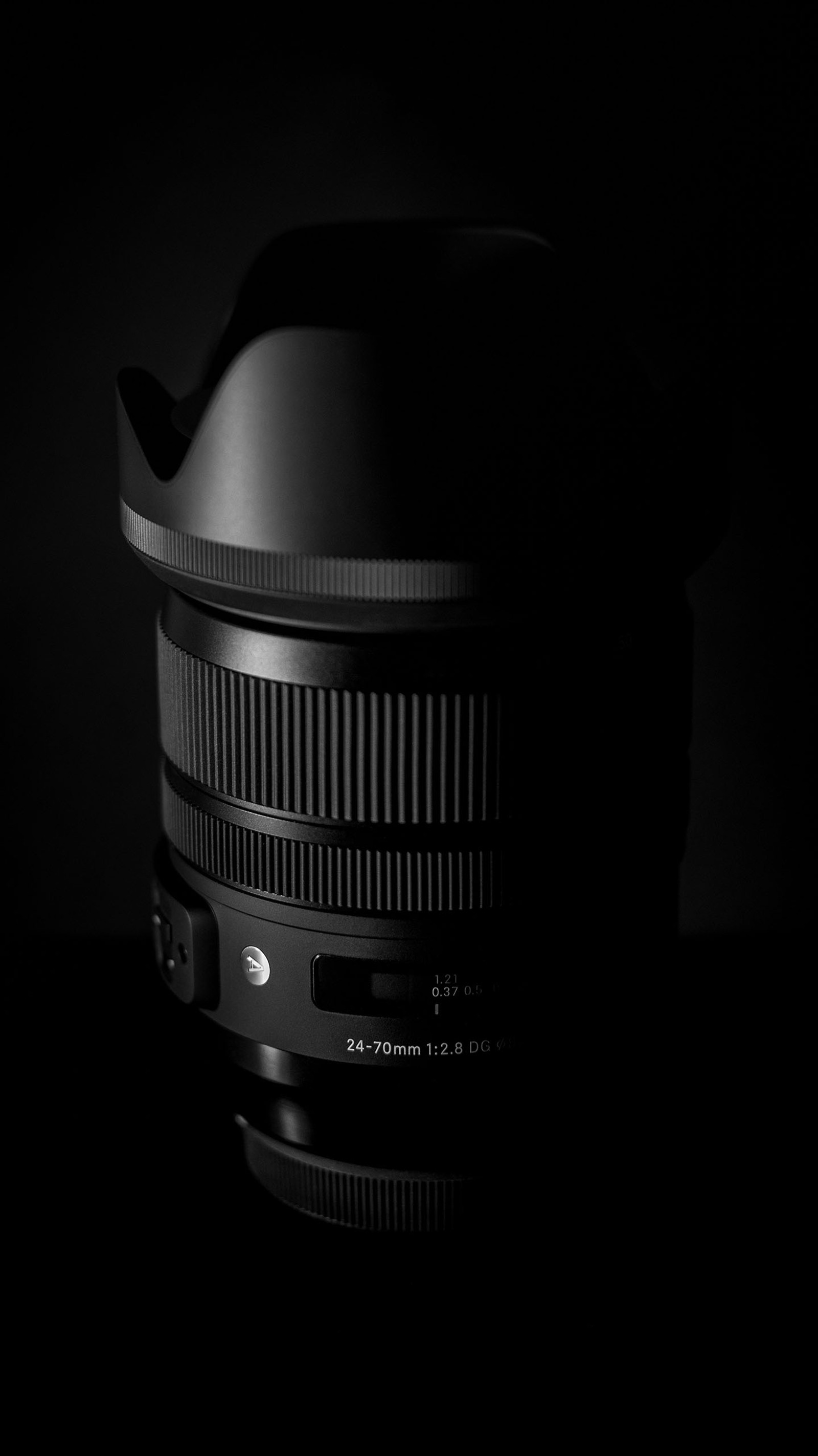 A close up of a lens in a dark room with a black background (amoled, black, camera, lens)