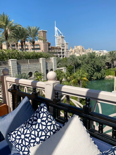 Majorelle Blue Balcony Overlooking Lush Palm Trees and Towering Architecture