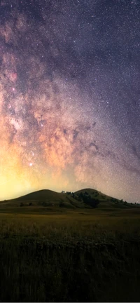 Milky Way Over Rolling Hills and Grassland