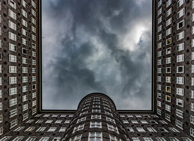 Architectural Marvel: A Unique Perspective of Modern Urban Design Against a Cloudy Sky