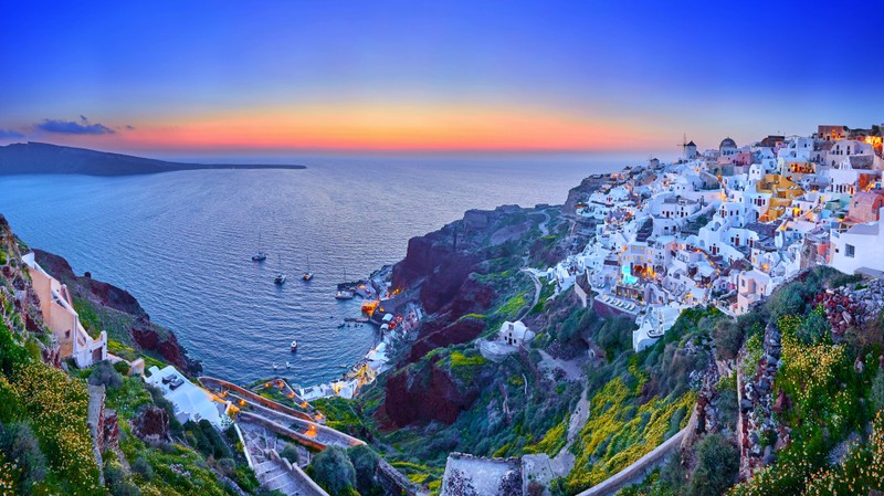 Вид на деревню на краю утеса с видом на океан (santorini island, тира, эгейское море, fira town, греция)