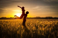 Abrazo alegre en un campo iluminado por el sol