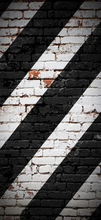 Diagonal Black and White Brickwork Pattern on a Stone Wall