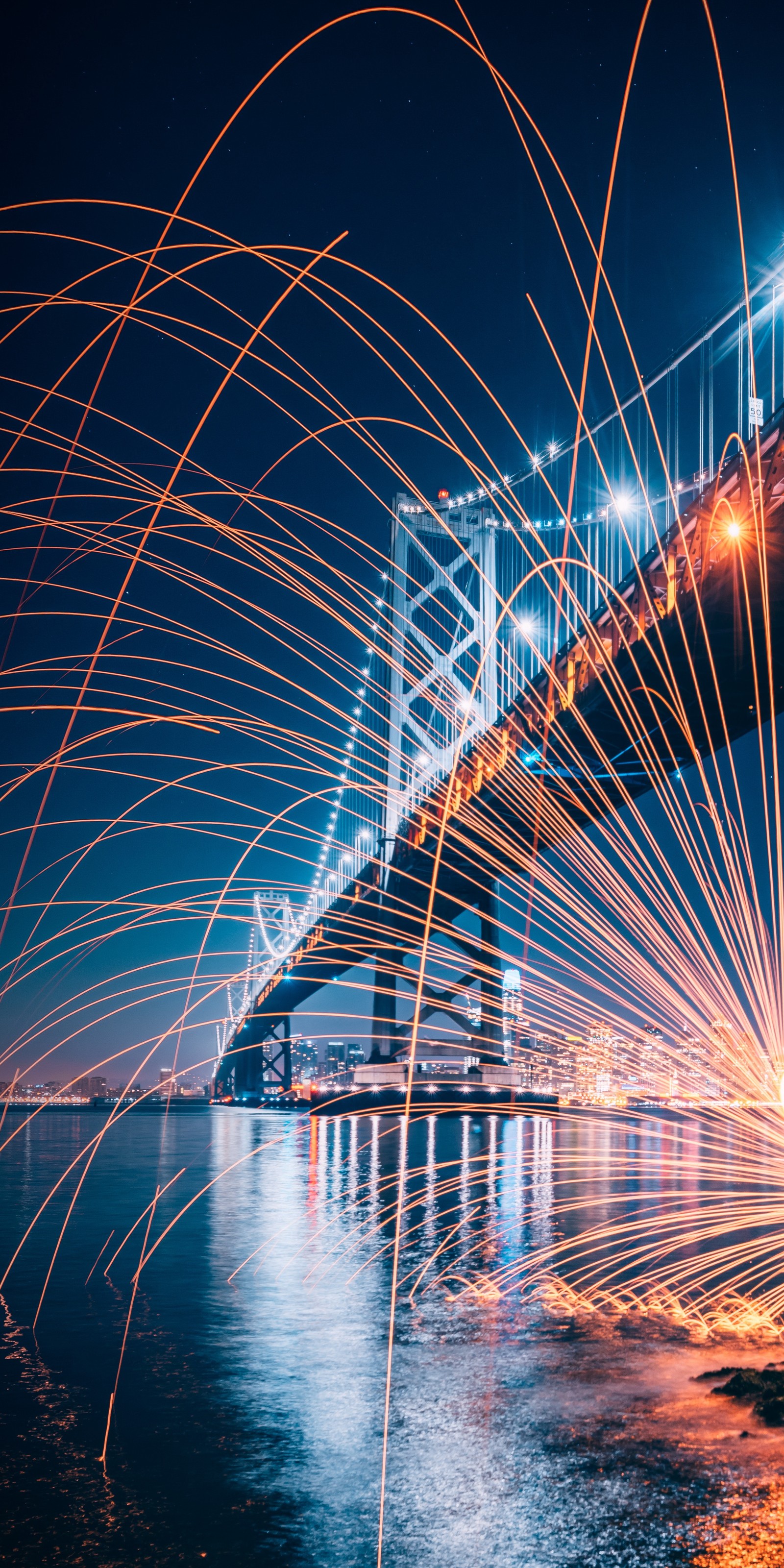 Arafed image of a bridge with sparks in the air (art, water, light, electricity, street light)