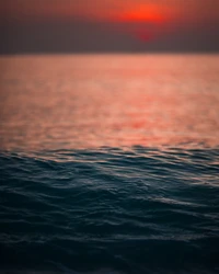 Tranquil Sunset Over Calm Ocean Waves