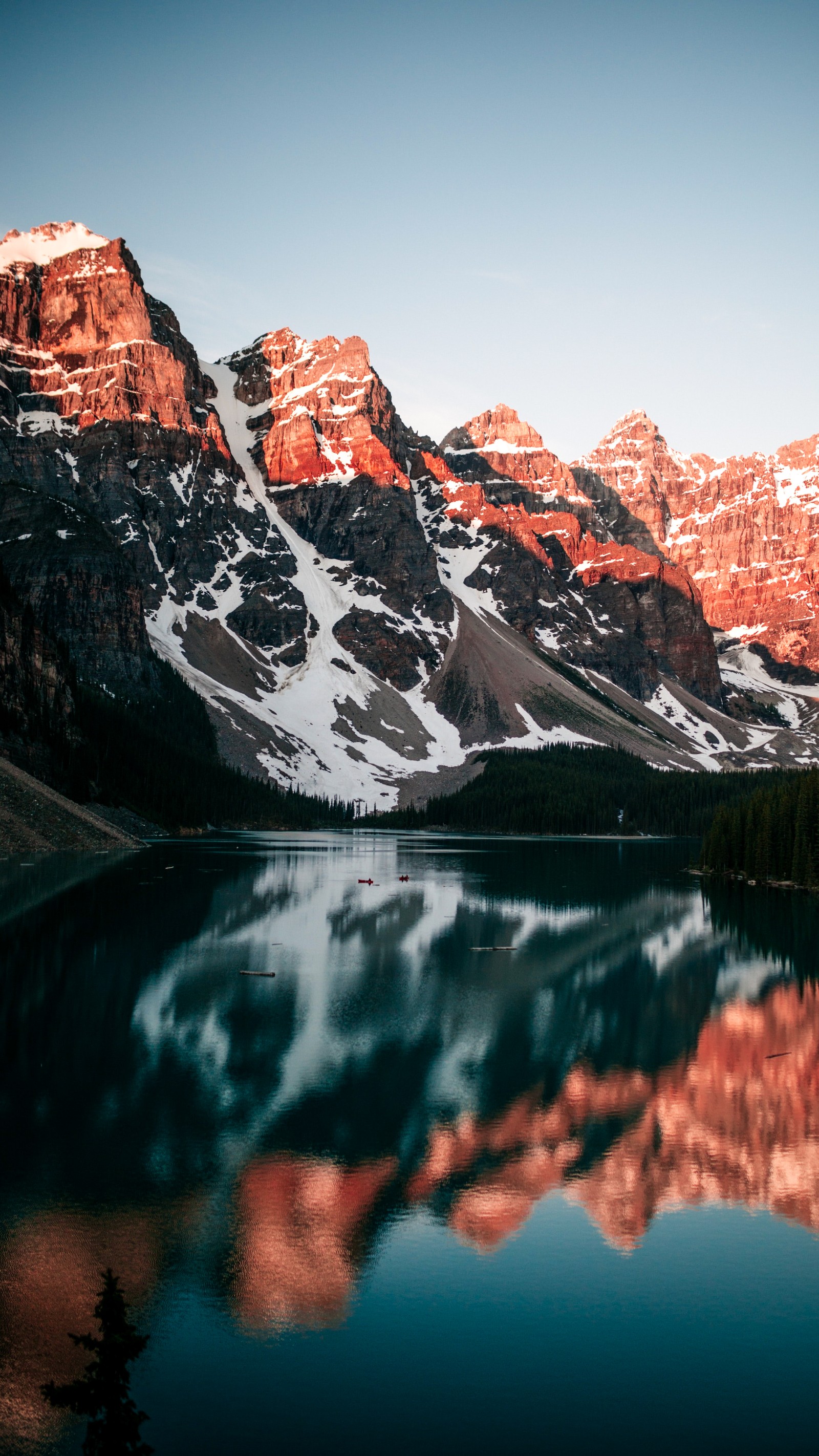 Mountains reflected in a lake with a clear sky (banff national park, moraine lake, banff, peyto lake, lake louise)