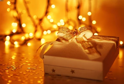 Elegant Christmas Gift Box with Golden Ribbon Against a Warm Glow of Holiday Lights