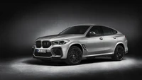 BMW X6 M: Sleek performance SUV with dynamic design and sporty alloy wheels.