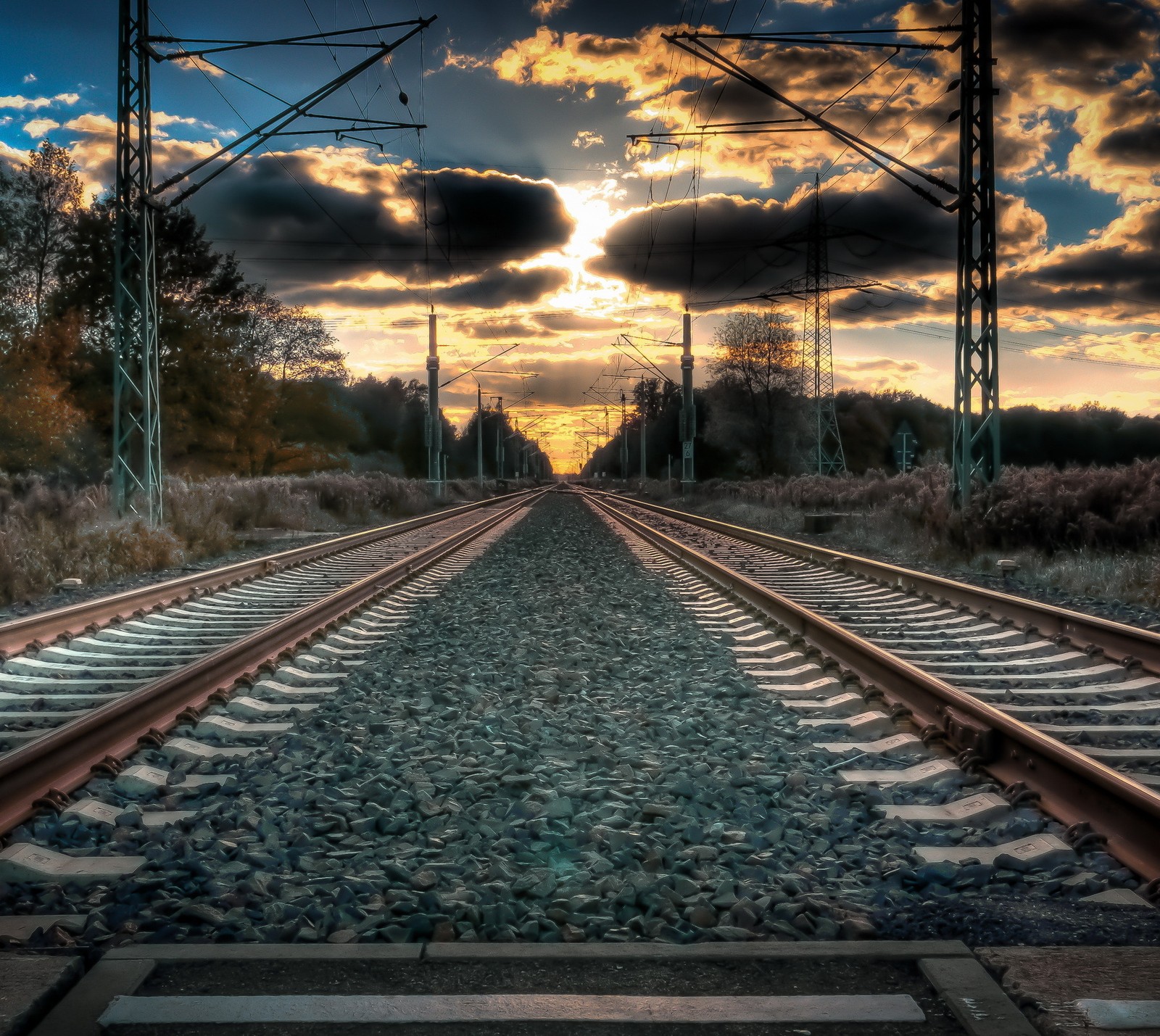 Arafed view of a train track with a sunset in the background (landscape, road, sunset, tracks railway, train)