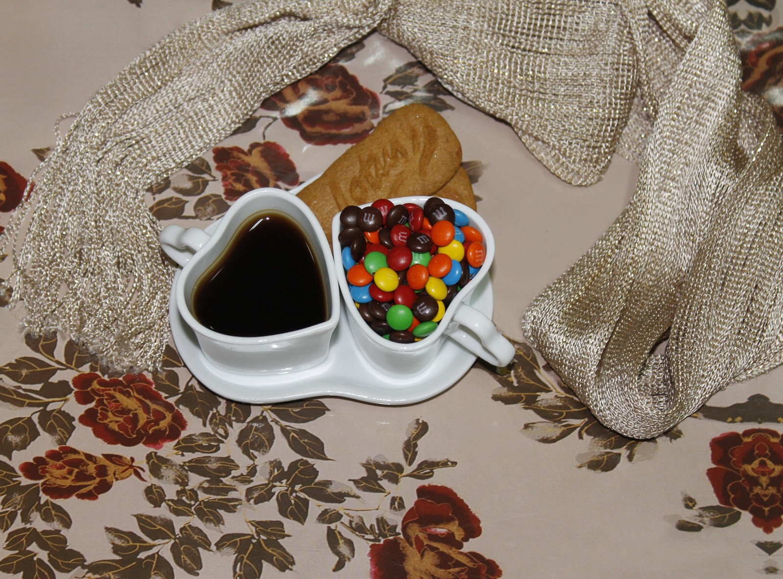 Il y a deux tasses de café et des bonbons sur une table (biscuit, bonbons, café, cœur, amour)