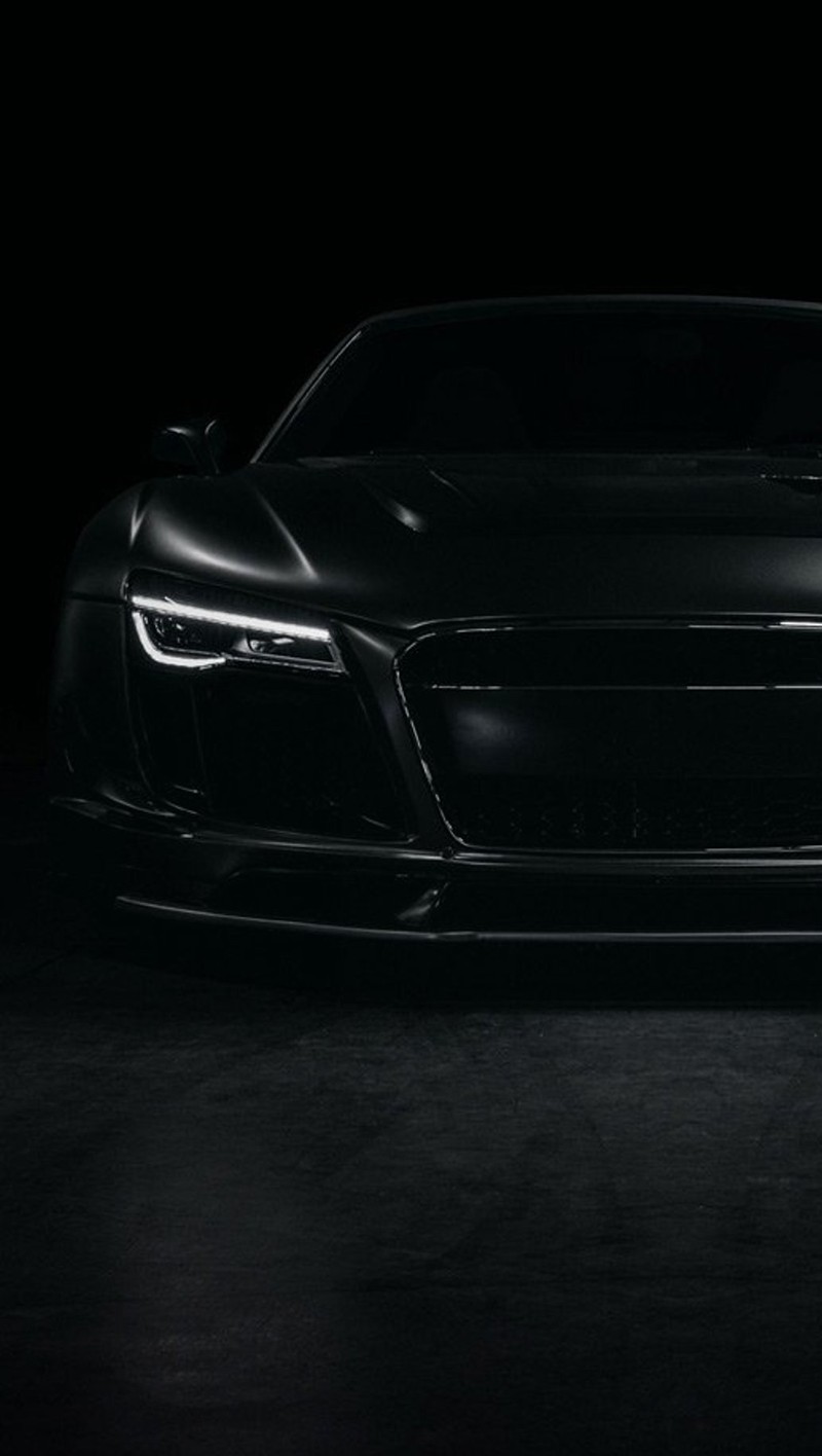 Крупный план черного спортивного автомобиля в темной комнате (black audi r8, глаз, белый)