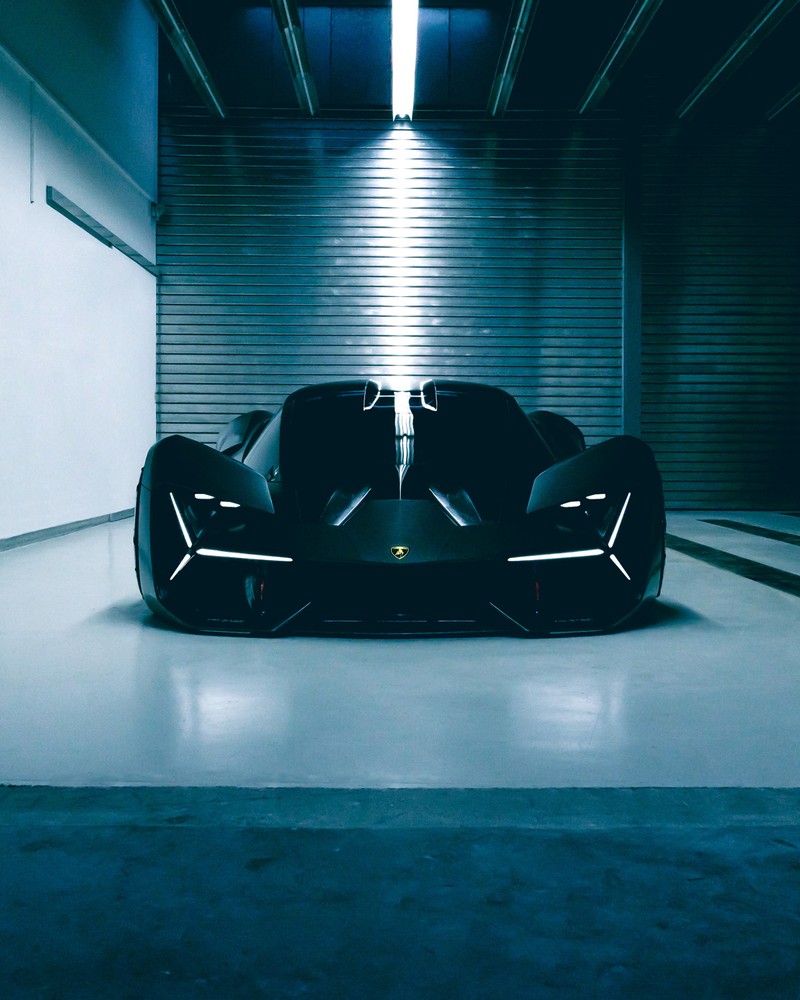 A close up of a black car in a garage with a light on (2019, car, cool, inovation, lamborghini)