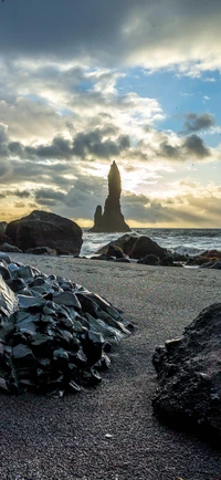 Majestic Rock Formation Against a Dramatic Sky by the Sea