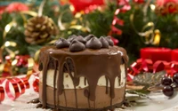 Decadent chocolate cake with fudge topping and chocolate chips, adorned with festive decorations.