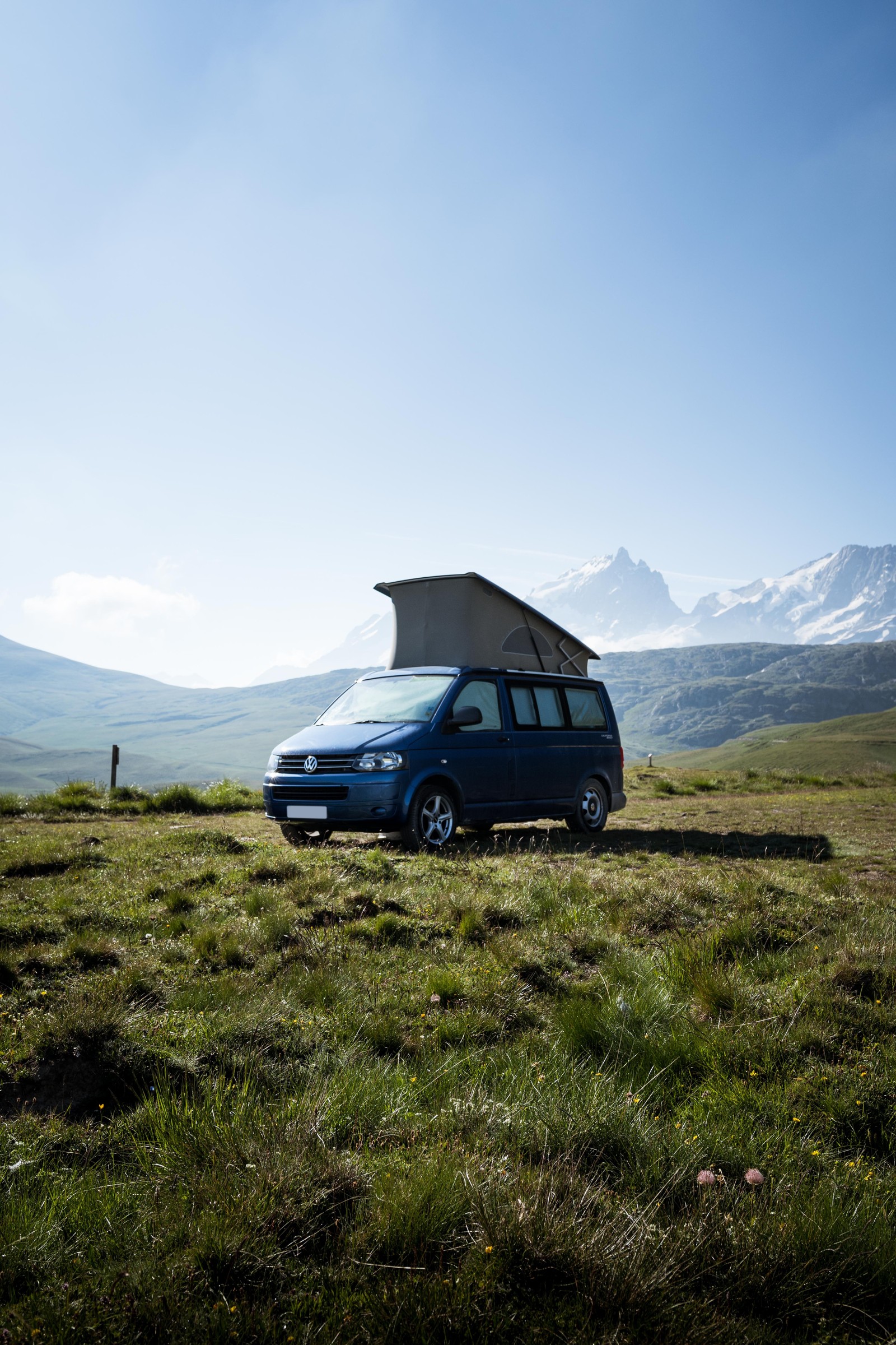 Arafed van parked in a field with a tent on top (volkswagen type 2, car, van, campervans, volkswagen)