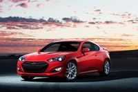 Elegante coupé rojo Hyundai contra un dramático atardecer