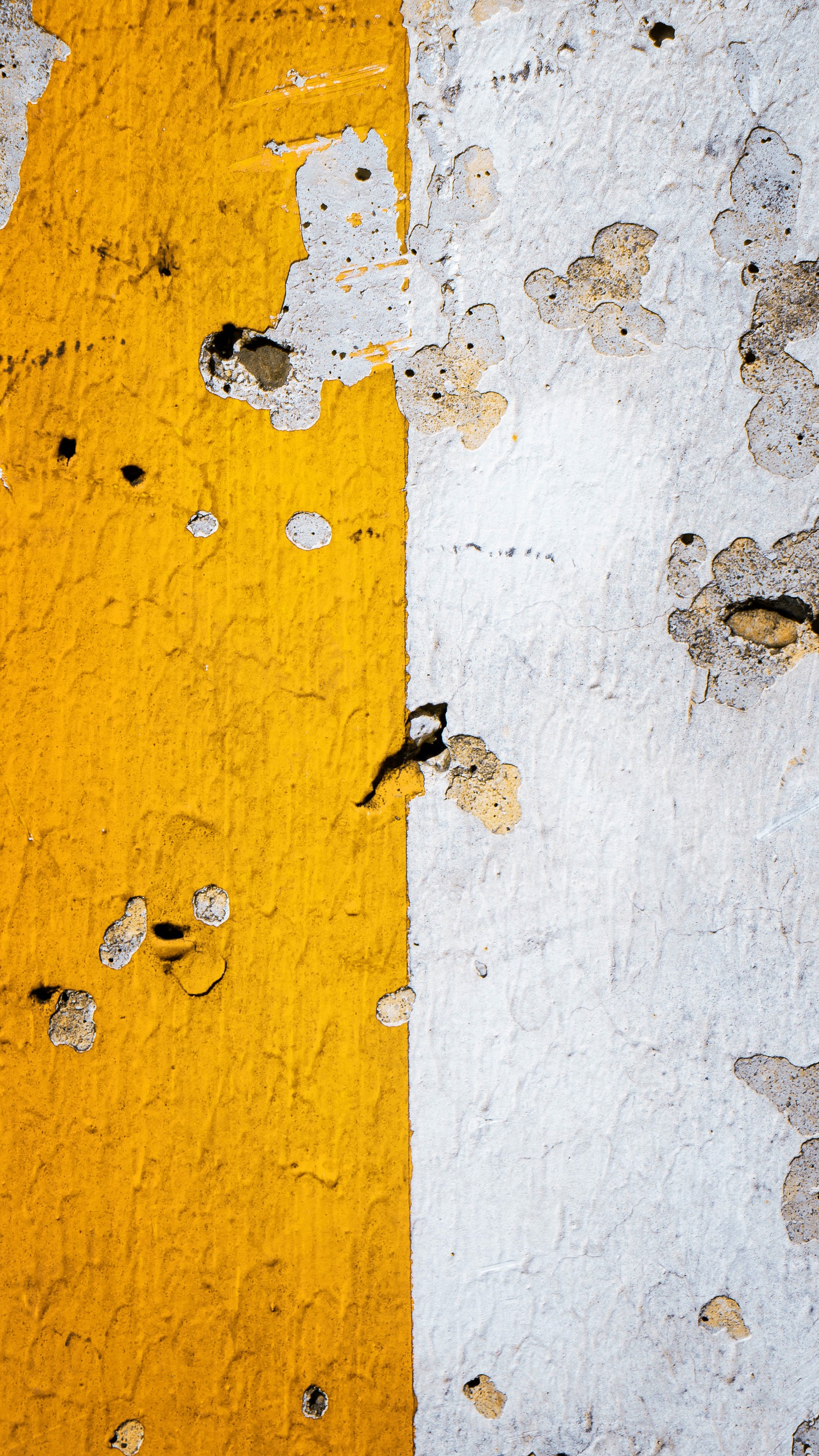 Yellow and white paint on a wall with a yellow stripe (wall, brown, wood, amber, yellow)