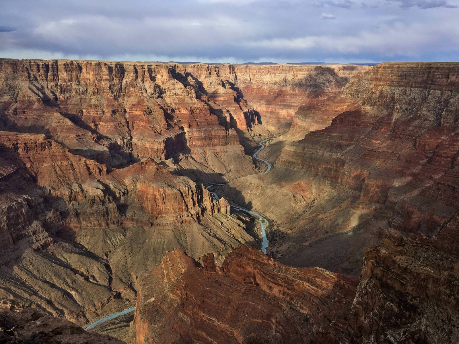 Arafed view of a canyon with a river running through it (badlands, canyon, formation, geology, rock)