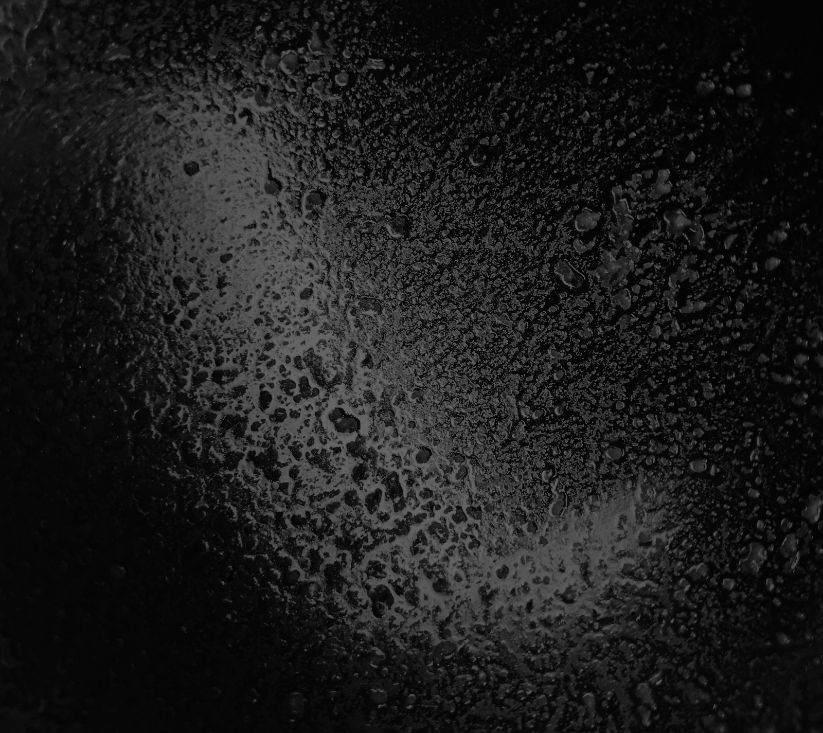 A close up of a black pan with water on it (black, cool, dark, dirty, messy)