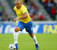 A dynamic moment of a Brazilian footballer in action, wearing the iconic yellow jersey with number 9, showcasing skill and determination on the field.