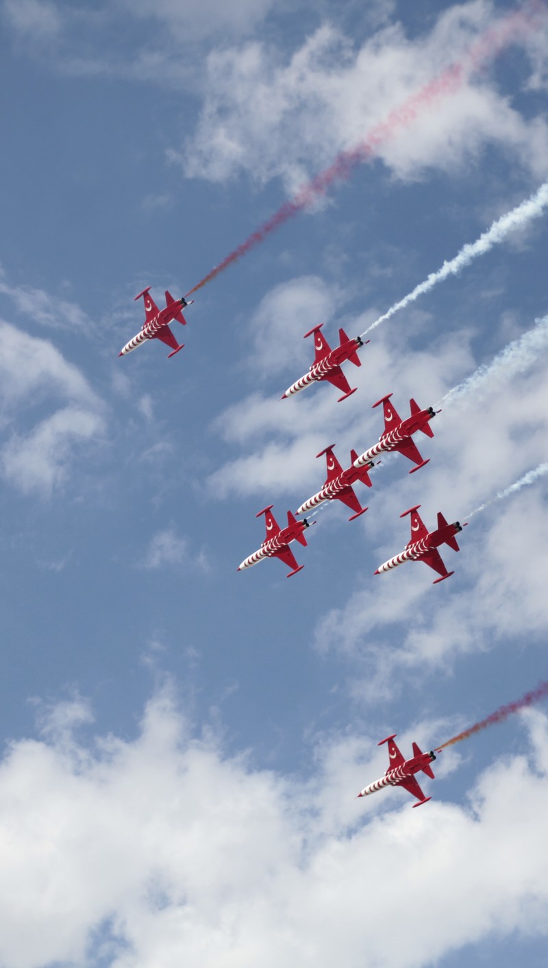 Arafed formation of red and white jets flying in formation (sky, turkish stars)