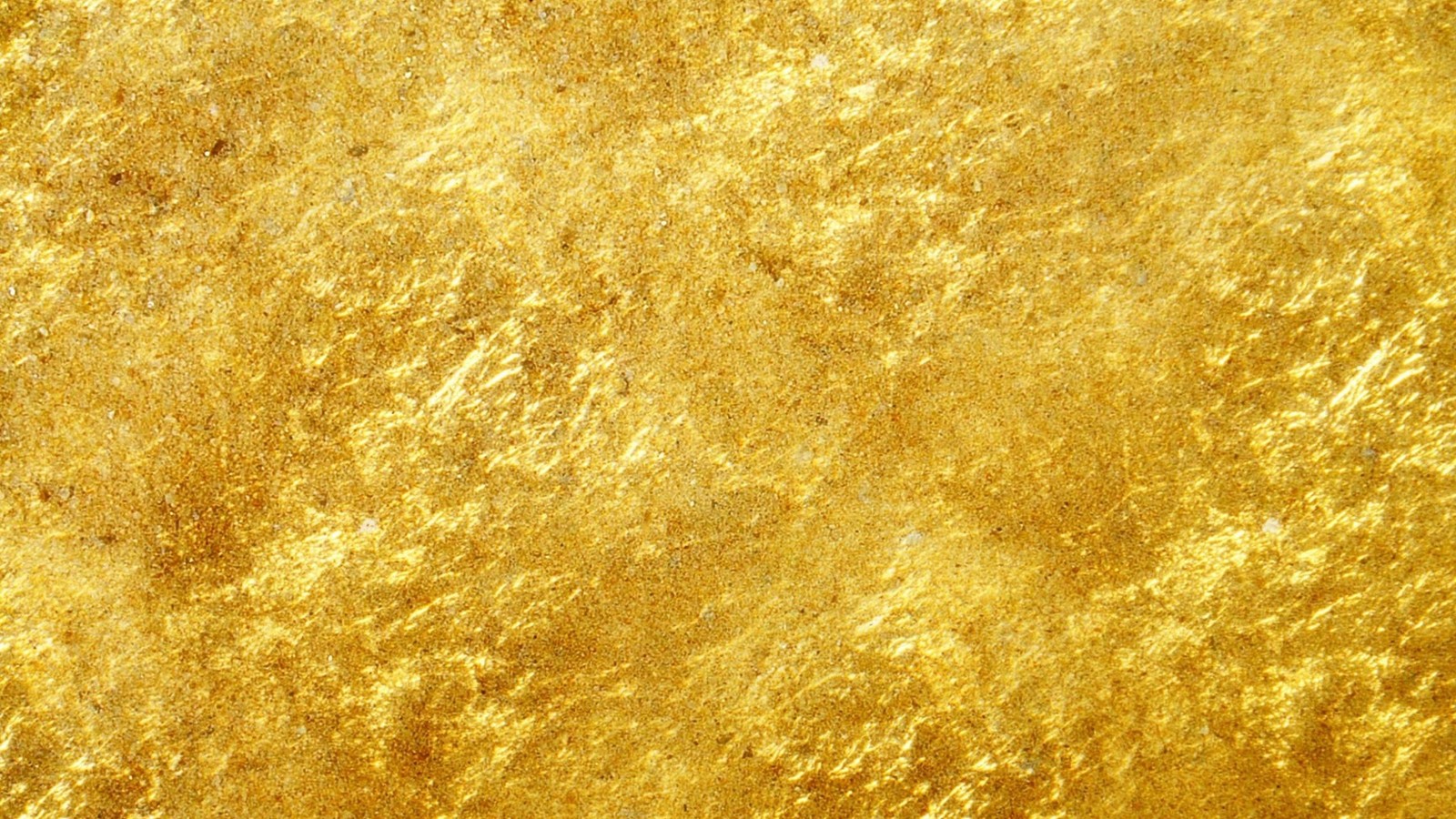 Un gros plan d'une surface texturée en feuille d'or sur fond noir (or, jaune, motif, ciel)