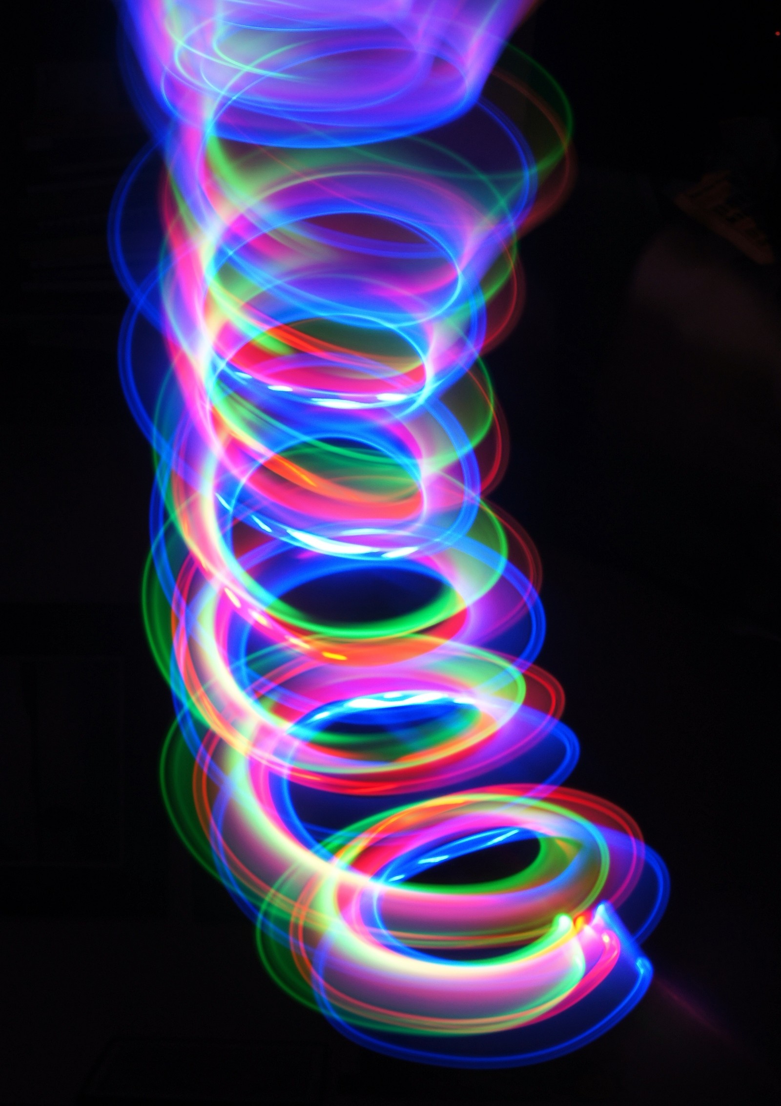 A close up of a long exposure of a light painting (light, visual effect lighting, neon, water, electric blue)