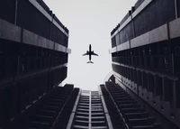 Monochrome Urban Flight: An Airplane Between Skyscrapers