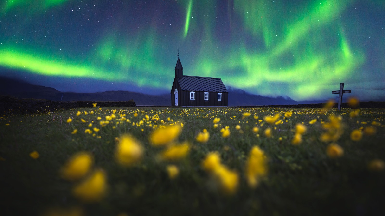 A church with a green aurora light in the sky (aurora borealis, church, northern lights, iceland, yellow flowers)