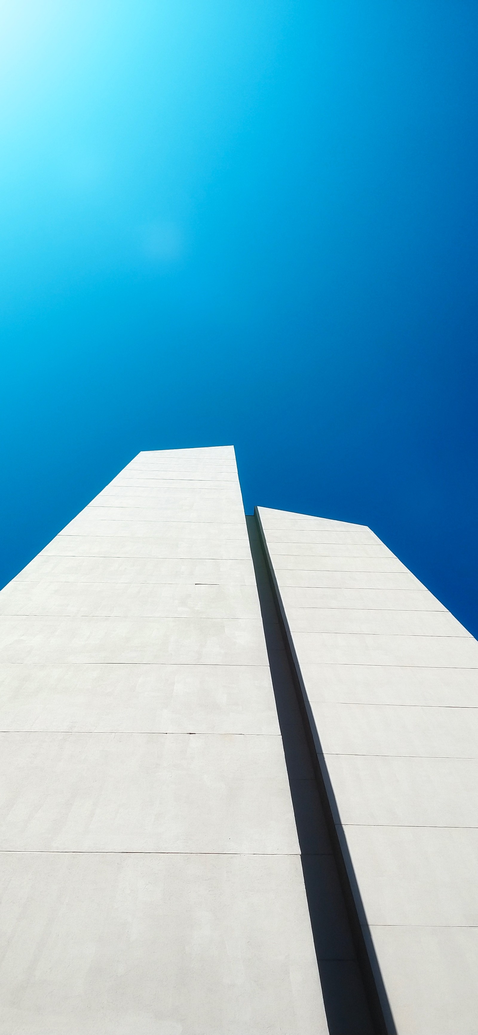 Arafed view of a building with a blue sky in the background (building, azure, rectangle, tower, wood)