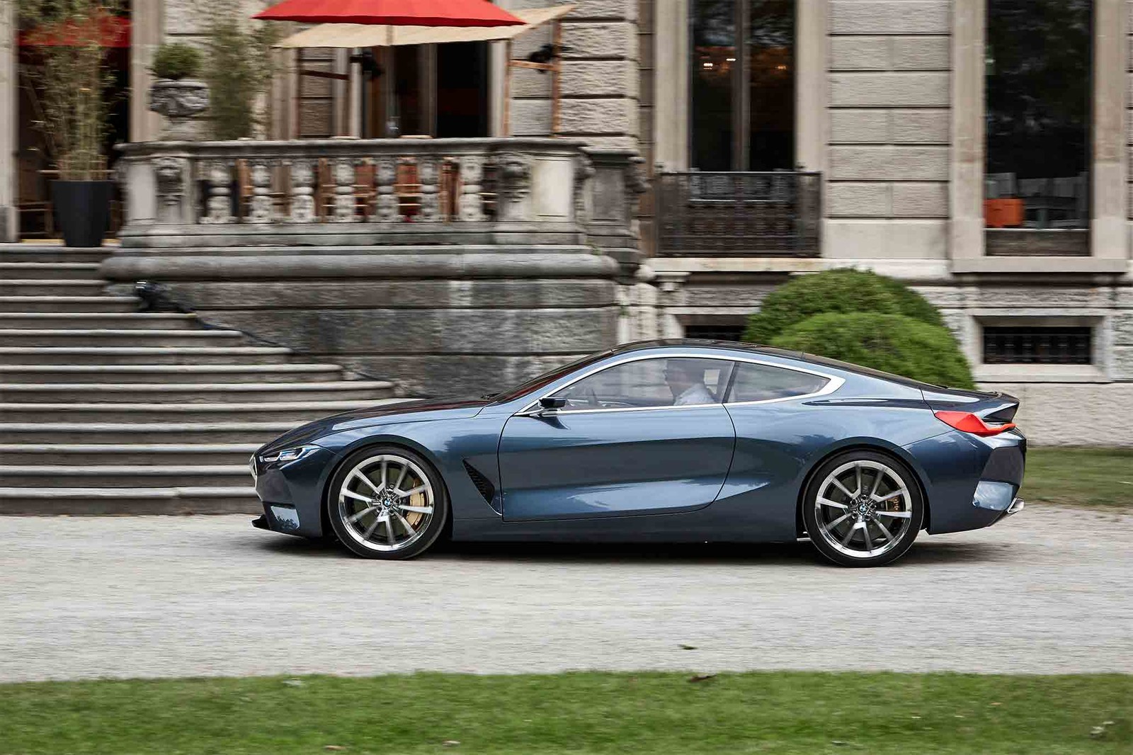 A close up of a blue sports car parked in front of a building (bmw 8 series, bmw, car, sports car, rim)