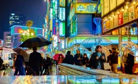 Vibrant Tokyo Night Market: A Bustling Urban Scene with Umbrellas and Neon Lights