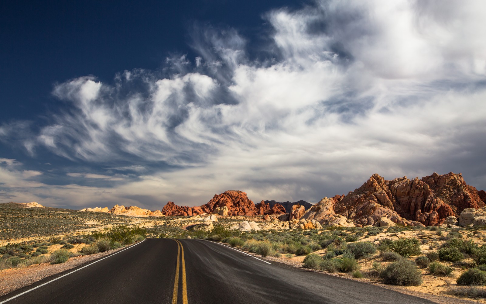 Arafed road in the desert with a cloudy sky (las vegas, mojave desert, yosemite valley, mountain, valley)