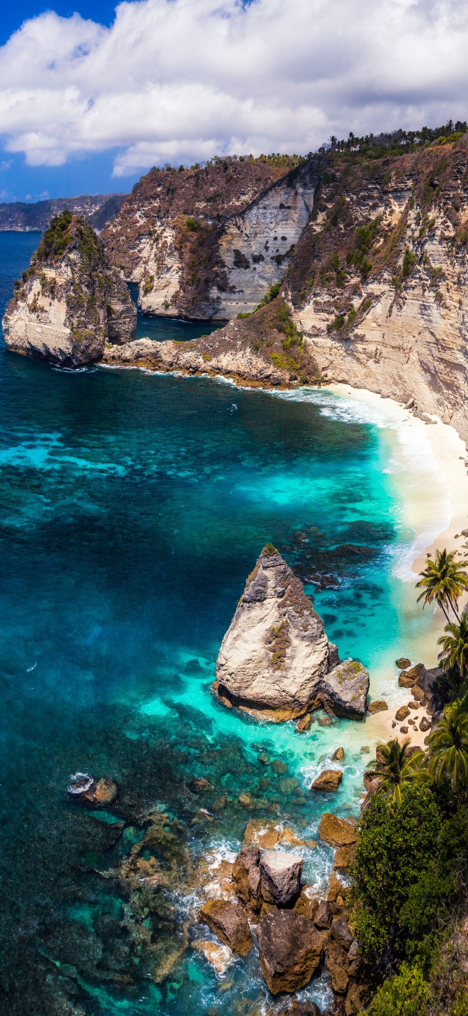 Arafed view of a beach with a boat in the water (bali, water, water resources, mountain, blue)