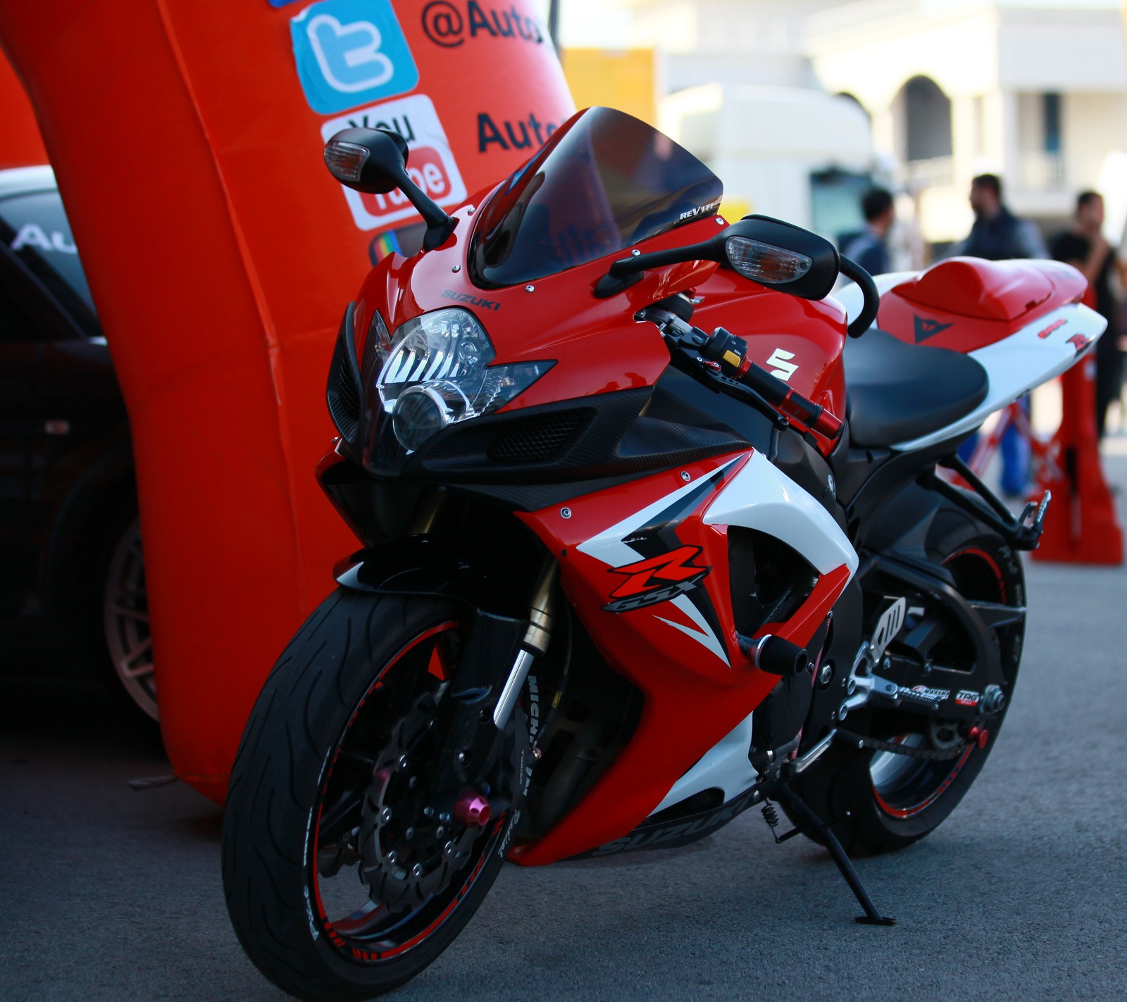 Motorcycle parked in front of a red and white tent with people standing around (freedom, gsx r, motorcycle, my life, ozgur)