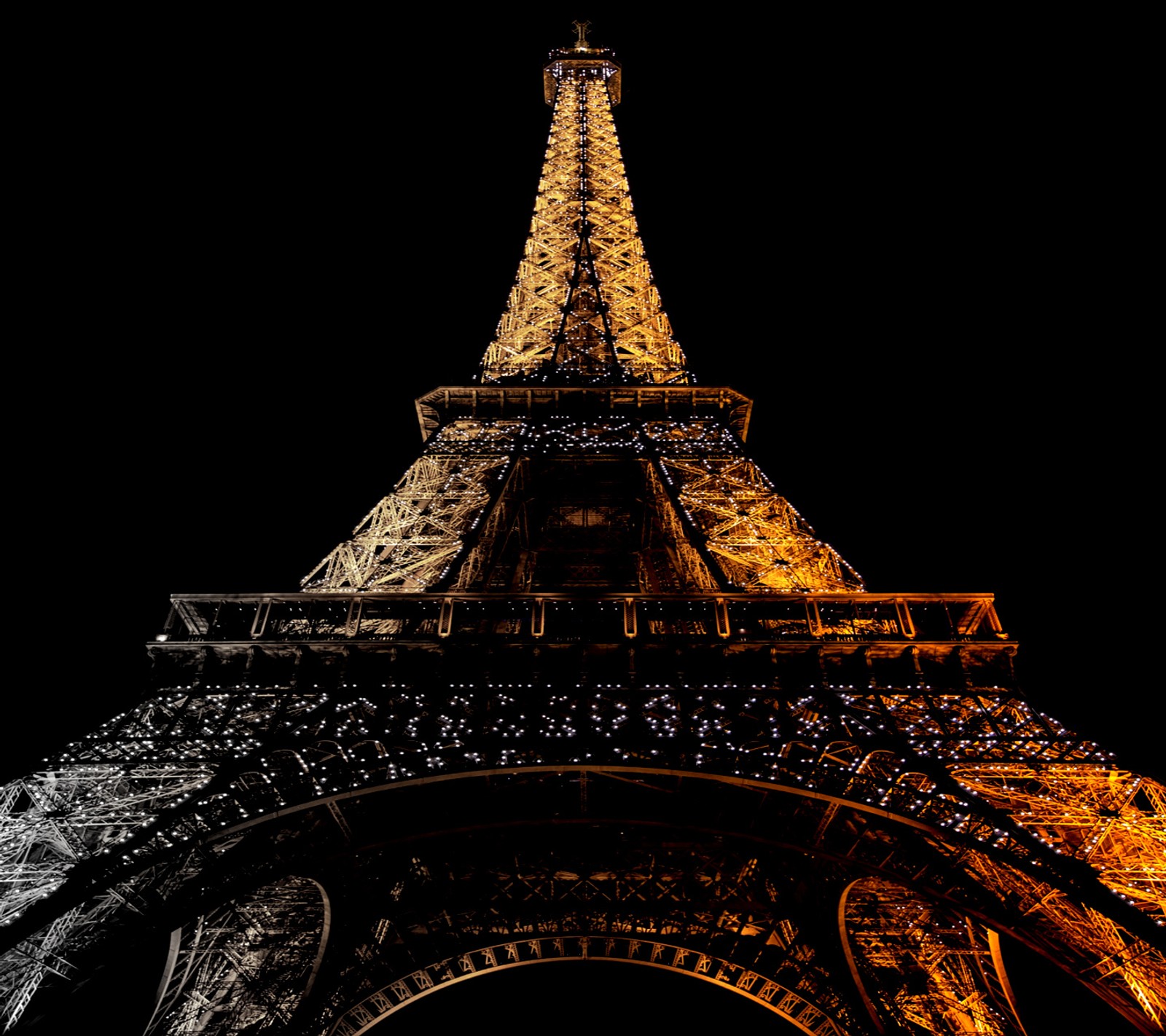 Arafed view of the eiffel tower lit up at night (eiffel tower, golden, lights, night, paris)