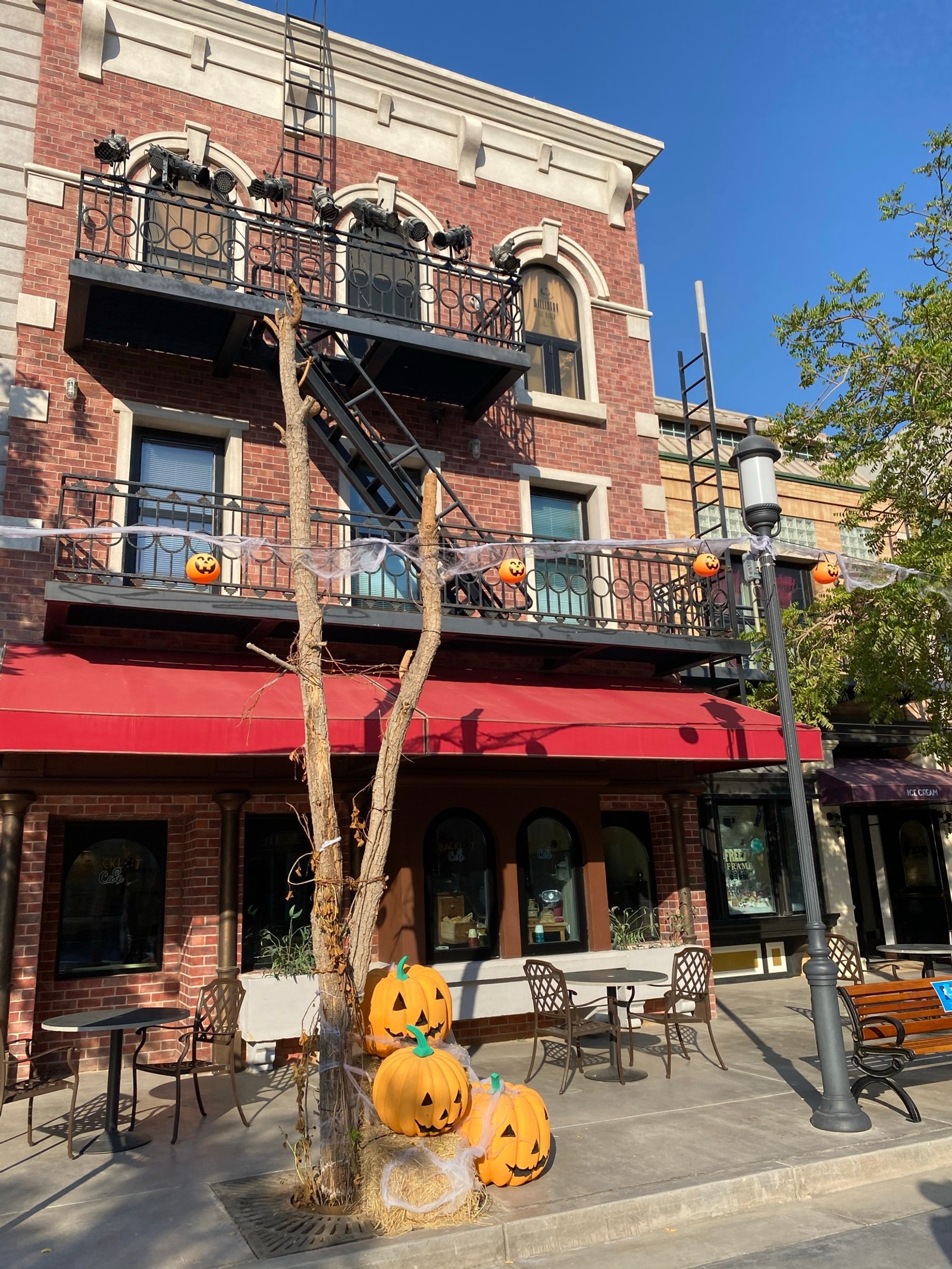 There is a large building with a red awning and a red awning (facade, building, vegetable, calabaza, brick)