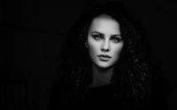 Striking Portrait of a Fair Woman with Green Eyes Against a Black Background