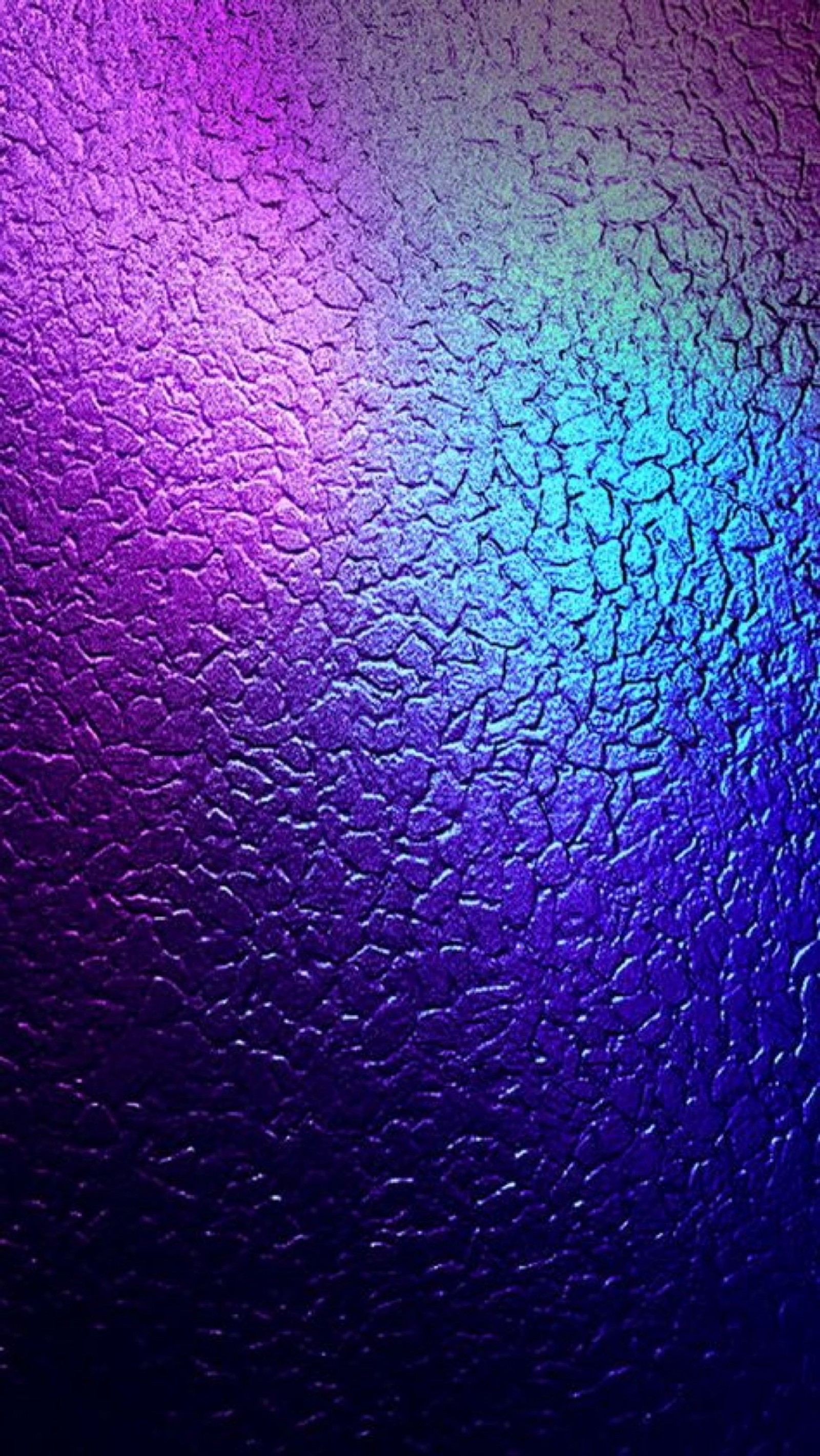 A close up of a glass with a rainbow light on it (smartphone, blue, purple, violet, water)