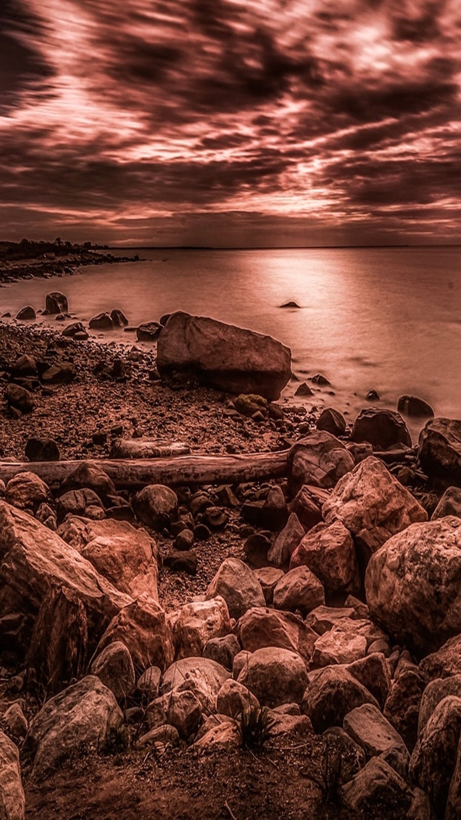 Arafed view of a rocky beach with a boat in the distance (landscape, nature)