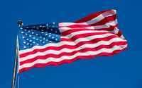 American Flag Waving Against a Clear Blue Sky