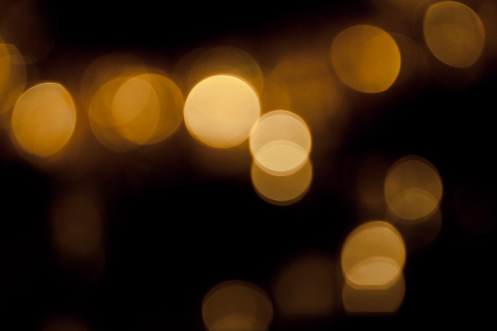 A close up of a cell phone with a blurry background (bokeh, texture, light, lighting, night)