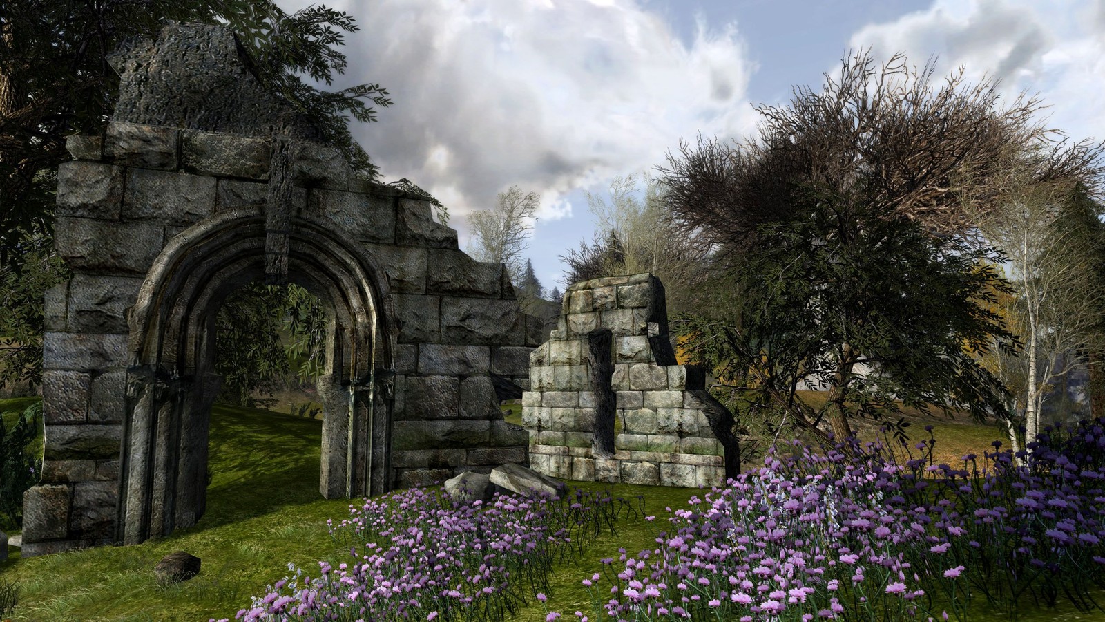 A close up of a stone arch in a garden with purple flowers (flower, the lord of the rings, spring, ruins, plant)