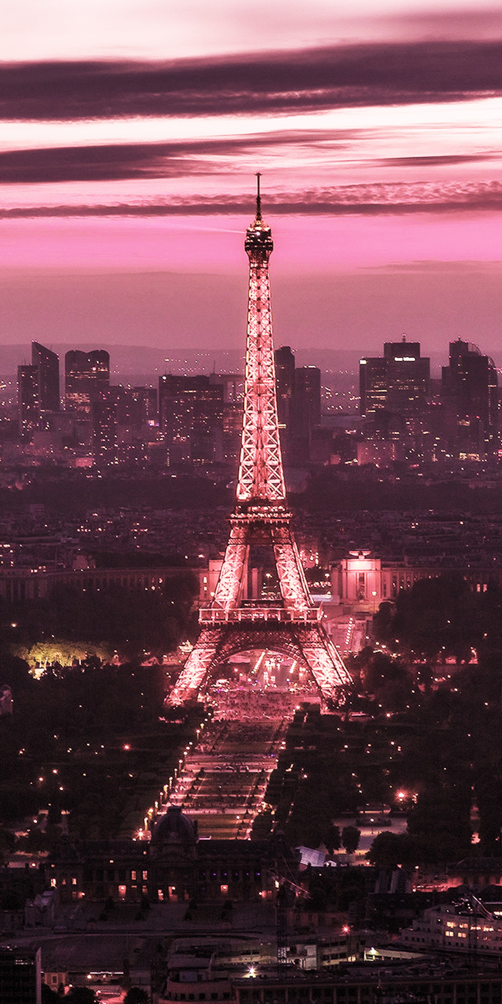 Araffe view of the eiffel tower at night with the city lights on (eiffel tower, france, landscape, paris, pink)