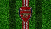 Arsenal FC Logo on Grass Texture Background