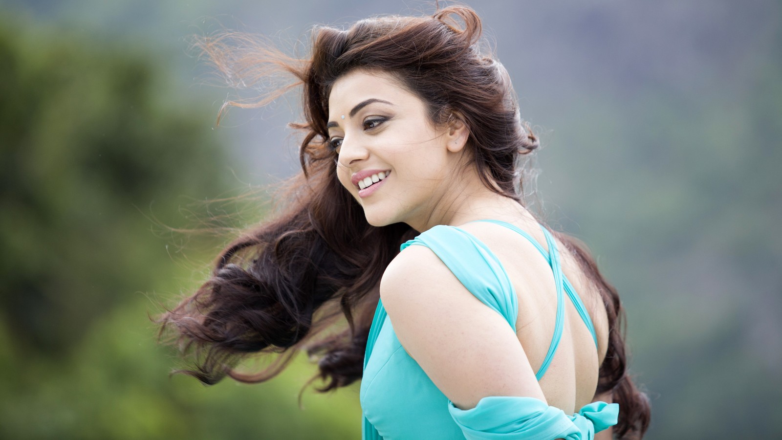 Araffe woman with long hair in a blue dress smiling (kajal aggarwal, 5k, indian actress, telugu actress, people)