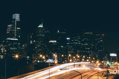 Illuminated Philadelphia Skyline at Night with Dynamic Traffic